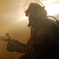 Silhouette of firefighter wearing a helmet inside a building